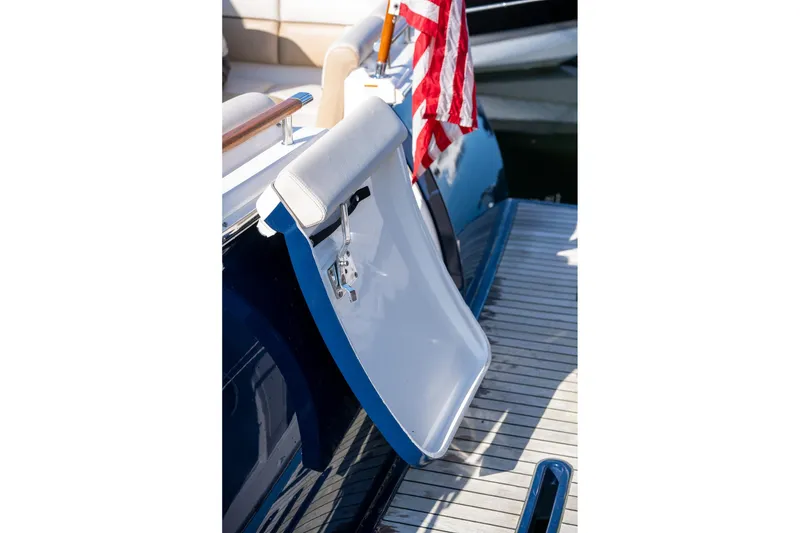 Slide: The Image of 2014 Tiara Yachts 3100 Coronet docked, featuring a beige cover and scenic waterfront. - 24
