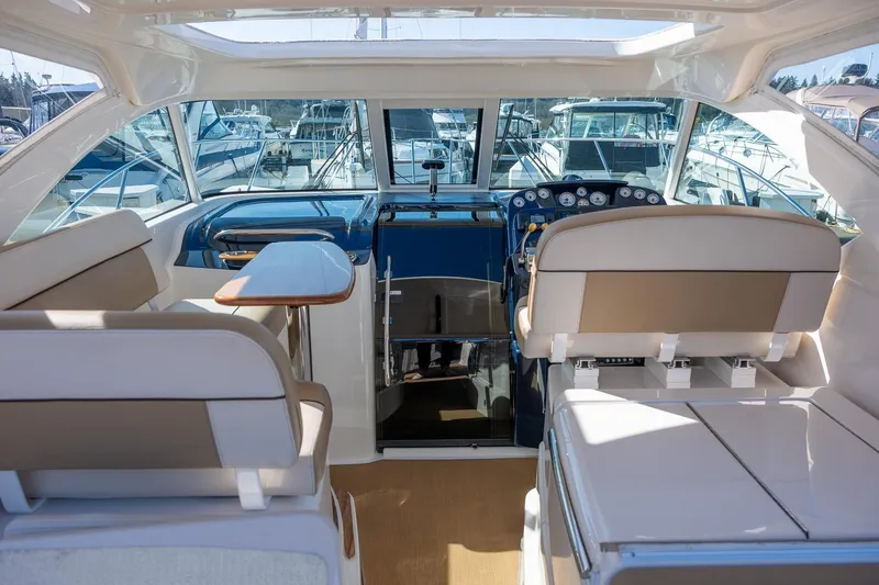 Slide: The Image of 2014 Tiara Yachts 3100 Coronet interior seating with marina view. - 29