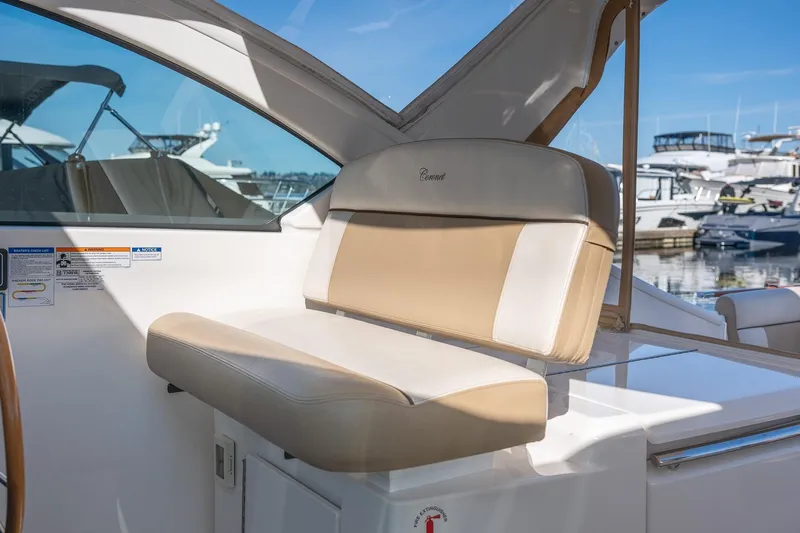 Slide: The Image of Interior of 2014 Tiara Yachts 3100 Coronet with seating and table, docked at marina. - 30