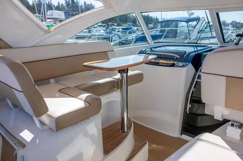 Slide: The Image of Interior of 2014 Tiara Yachts 3100 Coronet, featuring helm and seating area. - 31