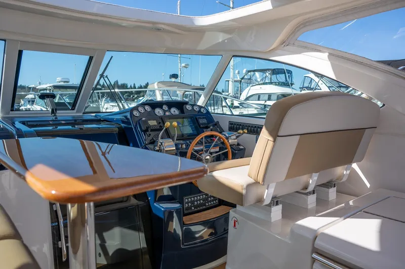 Slide: The Image of Cockpit of 2014 Tiara Yachts 3100 Coronet with navigation instruments and wooden steering wheel. - 34