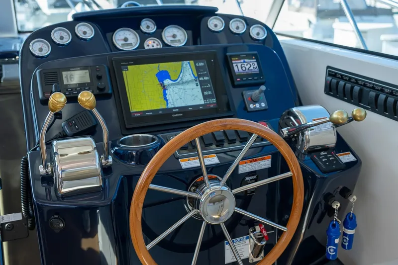 Slide: The Image of Dashboard of 2014 Tiara Yachts 3100 Coronet with gauges and navigation display. - 35
