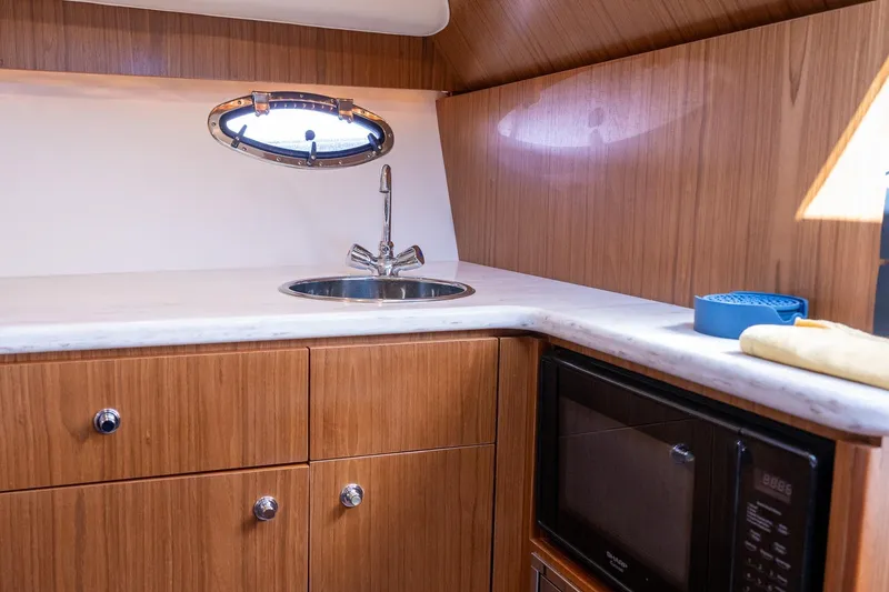 Slide: The Image of 2014 Tiara Yachts 3100 Coronet dashboard with cup holders and control panel. - 40