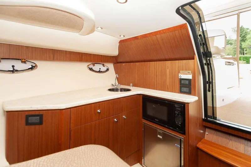 Slide: The Image of 2014 Tiara Yachts 3100 Coronet interior with microwave and stainless steel fridge. - 44