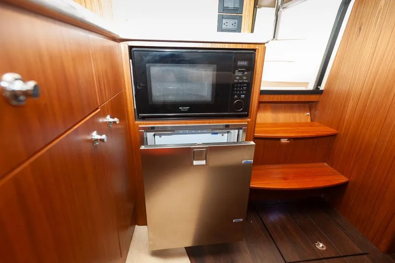 Slide: The Image of Interior cabin of 2014 Tiara Yachts 3100 Coronet with wood paneling and bed. - 45