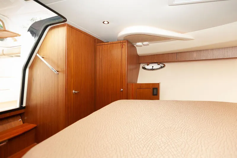 Slide: The Image of 2014 Tiara Yachts 3100 Coronet cabin interior with wooden cabinetry and safety equipment. - 46