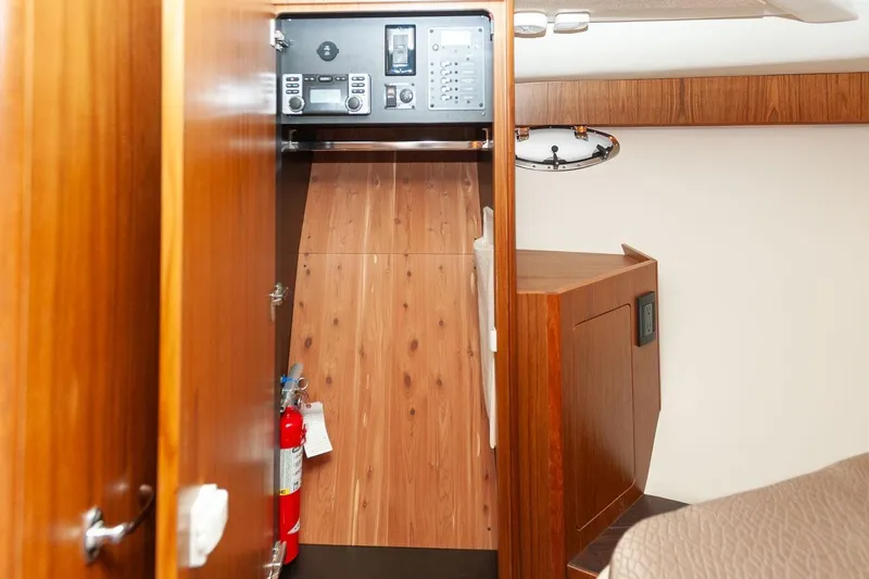 Slide: The Image of Interior of 2014 Tiara Yachts 3100 Coronet, featuring a compact bathroom with wooden accents. - 47