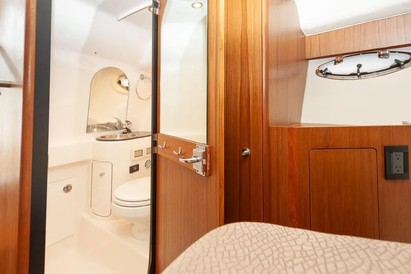 Slide: The Image of Luxurious bathroom interior of 2014 Tiara Yachts 3100 Coronet with sink and porthole window. - 48