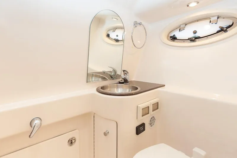 Slide: The Image of 2014 Tiara Yachts 3100 Coronet bathroom with sink, mirror, and toilet. - 49