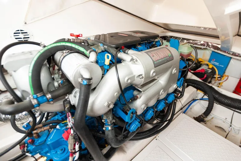 Slide: The Image of 2014 Tiara Yachts 3100 Coronet at marina, featuring open seating and American flag. - 53
