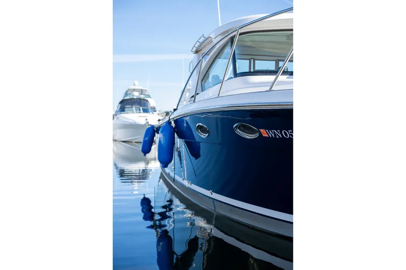 Slide: The Image of 2014 Tiara Yachts 3100 Coronet docked, showcasing sleek bow design and railing. - 6