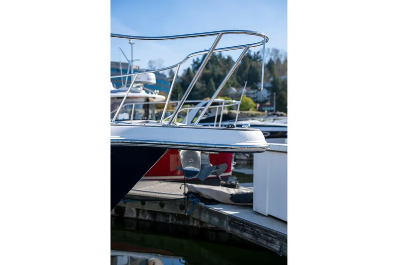 Slide: The Image of 2014 Tiara Yachts 3100 Coronet interior with seating and wooden table, docked at marina. - 8