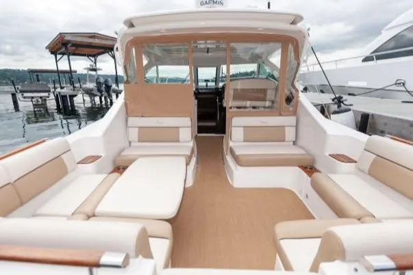 Slide: The Image of 2014 Tiara Yachts 3100 Coronet boat seating area at marina. - 9