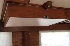 Slide: The Image of Interior view of a 1996 Nordic Tug 32, showcasing wooden cabinetry detail. - 11