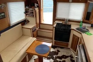 Slide: The Image of Interior of a 1996 Nordic Tug 32 with cozy seating and kitchen area. - 13