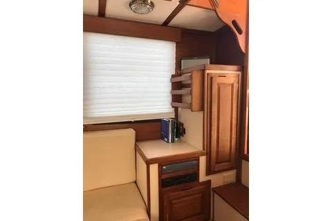 Slide: The Image of Interior of a 1996 Nordic Tug 32, featuring wooden cabinetry and seating. - 16