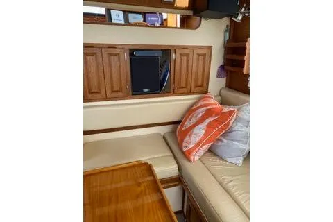 Slide: The Image of Cozy interior of 1996 Nordic Tug 32 with cushions and wooden cabinetry. - 19