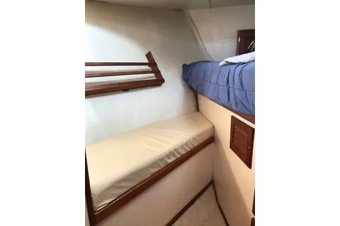 Slide: The Image of 1996 Nordic Tug 32 interior cabin with bunk beds and wooden accents. - 21