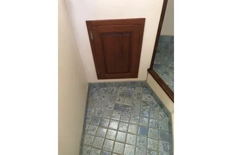 Slide: The Image of Small wooden cabinet door on tiled floor, Nordic Tug 32, 1996 model. - 25