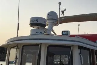 Slide: The Image of 1996 Nordic Tug 32 boat with Garmin radar and communication equipment on deck. - 3
