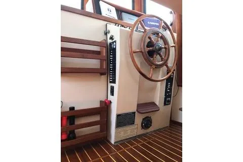 Slide: The Image of 1996 Nordic Tug 32 helm with wooden steering wheel and control panel. - 4