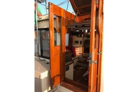 Slide: The Image of 1996 Nordic Tug 32 interior view through open wooden door. - 8