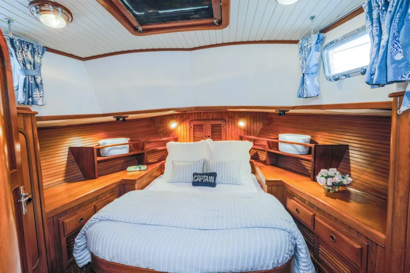 Slide: The Image of Cozy cabin interior of 1990 Hans Christian Independance yacht with wooden decor and nautical bedding. - 13