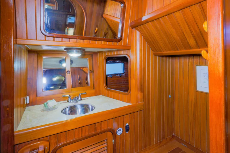 Slide: The Image of Wood-paneled bathroom interior of 1990 Hans Christian Independance yacht with sink and mirrors. - 16