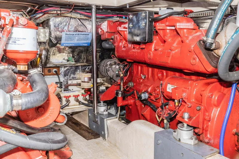 Slide: The Image of Engine room of 1990 Hans Christian Independance yacht with red machinery and wiring. - 18