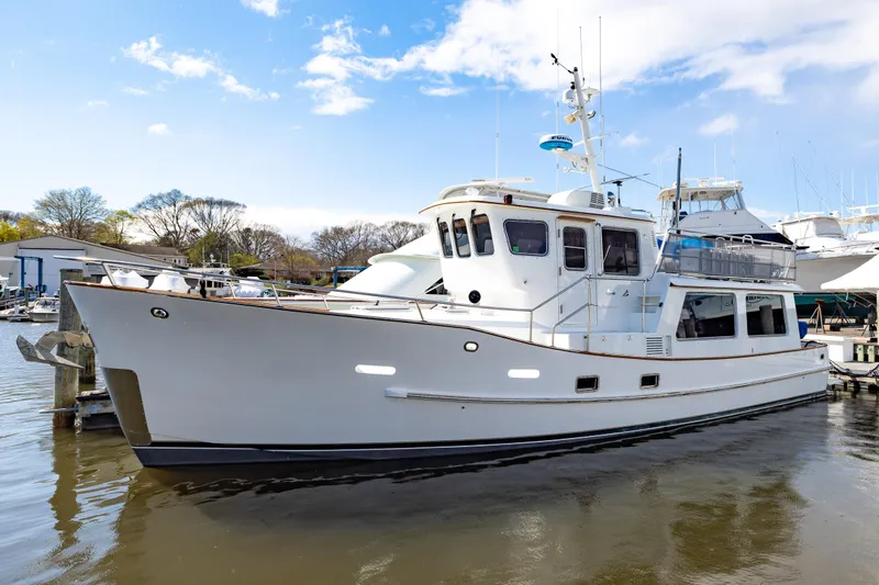 Slide: The Image of 1990 Hans Christian Independance yacht docked at marina under blue sky. - 20