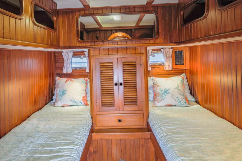 Slide: The Image of Cozy wooden cabin interior of 1990 Hans Christian Independance yacht with twin beds and nautical decor. - 4