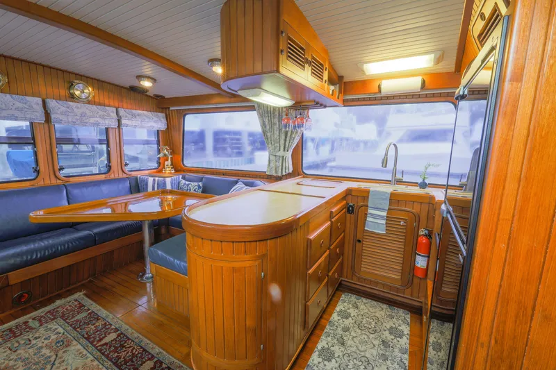 Slide: The Image of Luxurious 1990 Hans Christian Independance yacht interior with wooden cabinetry and cozy seating area. - 6