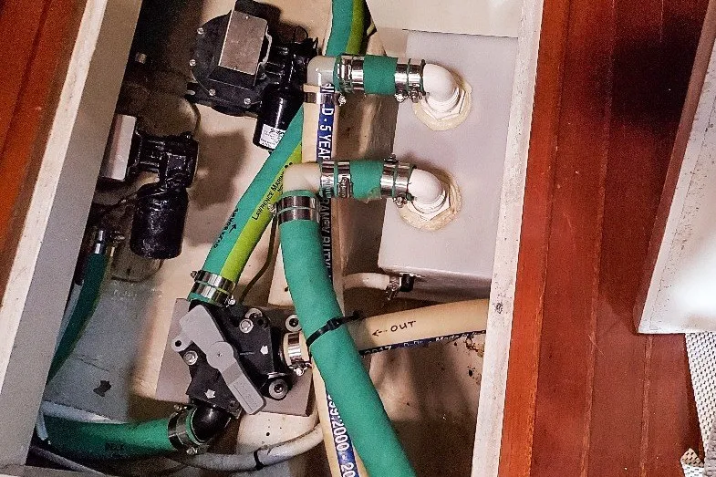 Slide: The Image of Engine compartment of 1990 Hans Christian Independance with green hoses and mechanical components. - 18
