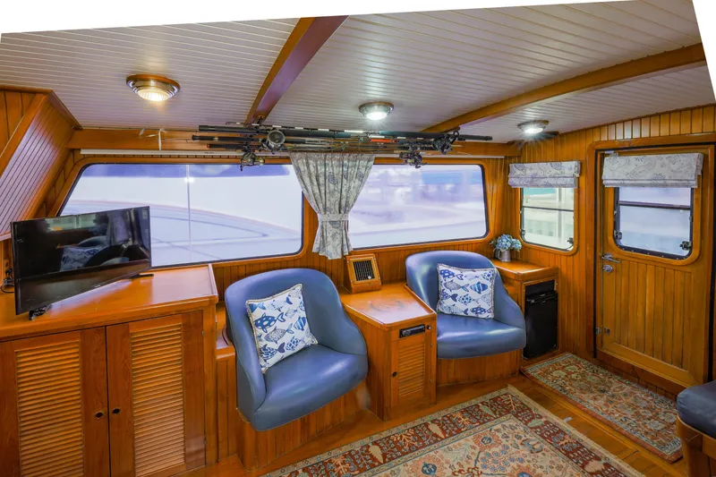 Slide: The Image of Cozy 1990 Hans Christian Independance yacht interior with wood paneling, seating, and decor. - 9