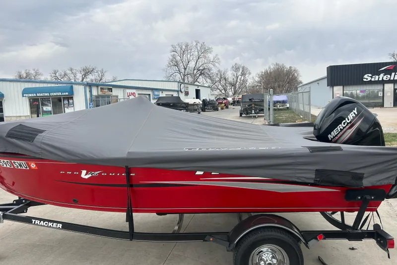 Slide: The Image of 2016 Tracker Pro Guide V-16 SC boat with cover, parked on trailer, Mercury engine visible. - 11