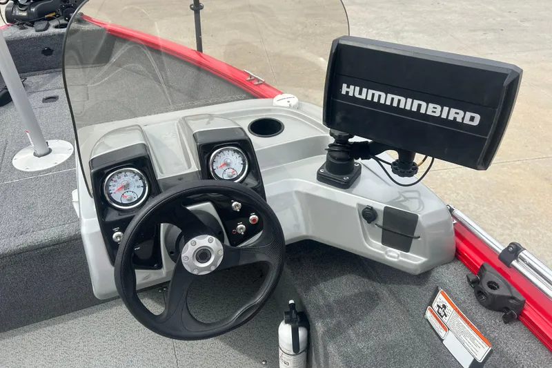 Slide: The Image of 2016 Tracker Pro Guide V-16 SC boat dashboard with steering wheel and Humminbird fish finder. - 12