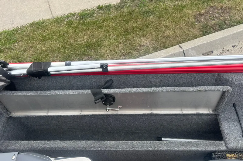 Slide: The Image of 2016 Tracker Pro Guide V-16 SC boat interior with rod storage compartment. - 13