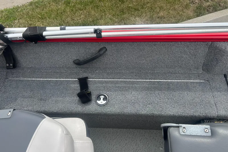 Slide: The Image of 2016 Tracker Pro Guide V-16 SC boat interior with gray seating and rod storage. - 15