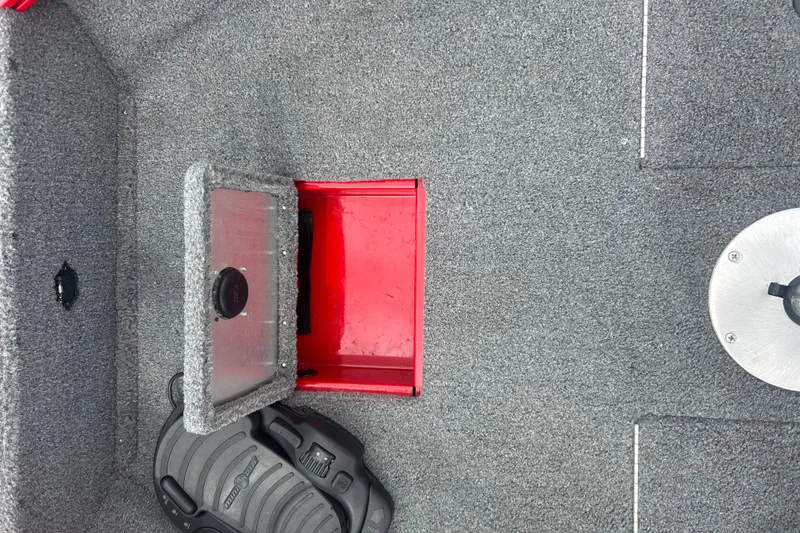 Slide: The Image of 2016 Tracker Pro Guide V-16 SC boat interior with storage compartment and pedal. - 16