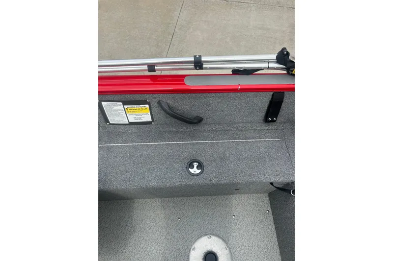 Slide: The Image of 2016 Tracker Pro Guide V-16 SC boat interior with red trim and gray flooring. - 19