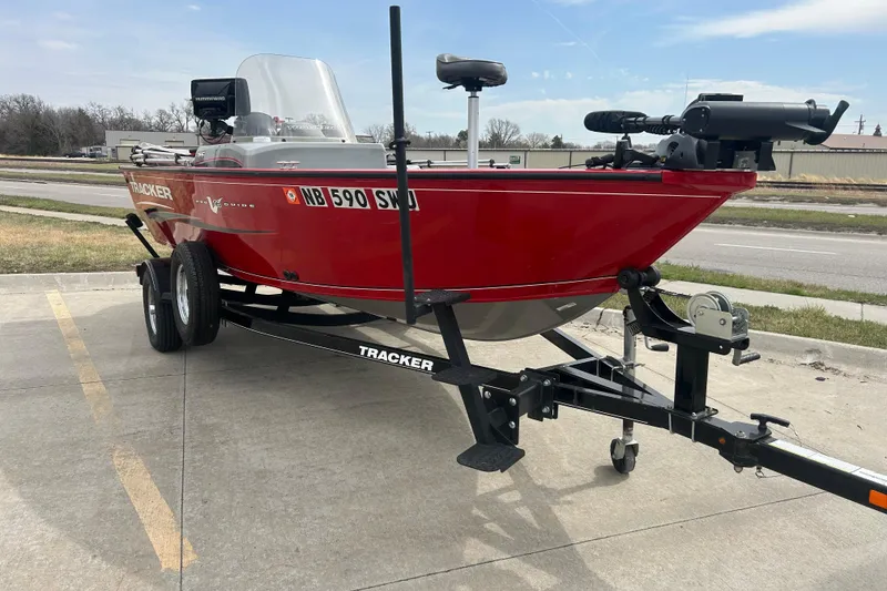Slide: The Image of 2016 Tracker Pro Guide V-16 SC boat on trailer, parked outdoors. - 2