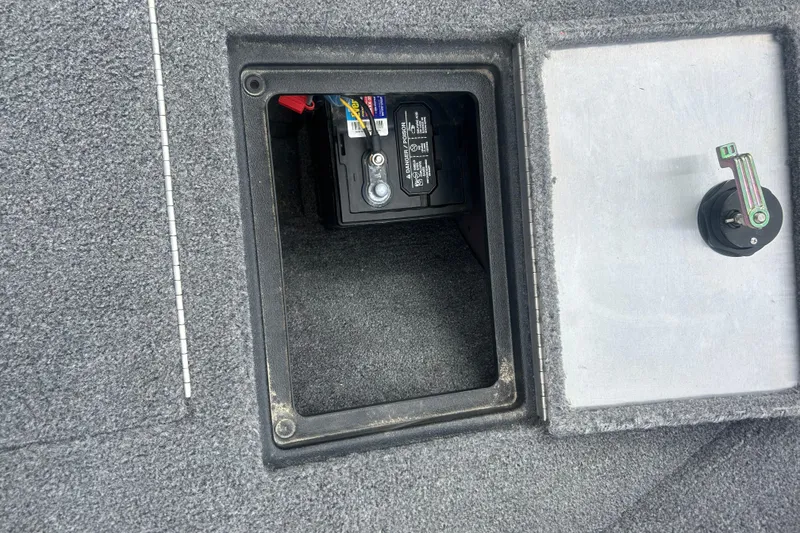 Slide: The Image of 2016 Tracker Pro Guide V-16 SC boat battery compartment with open hatch. - 21