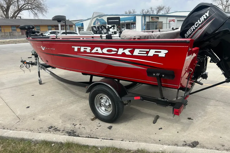Slide: The Image of 2016 Tracker Pro Guide V-16 SC boat in vibrant red on a trailer. - 4