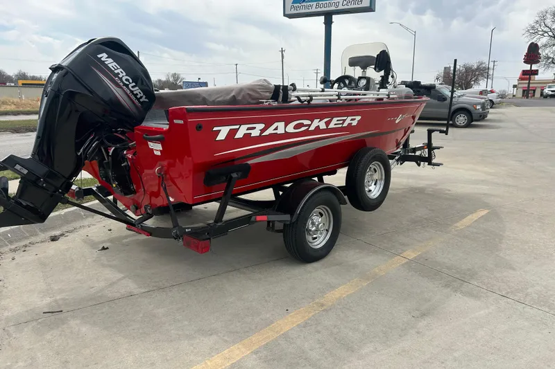 Slide: The Image of 2016 Tracker Pro Guide V-16 SC boat with Mercury engine on trailer in parking lot. - 6