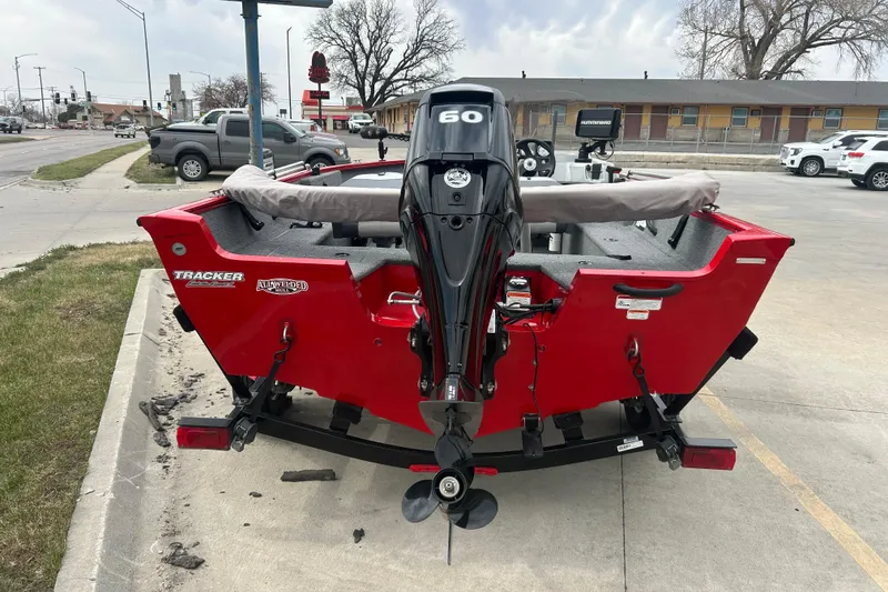 Slide: The Image of 2016 Tracker Pro Guide V-16 SC boat with a 60 HP motor, parked outdoors. - 7