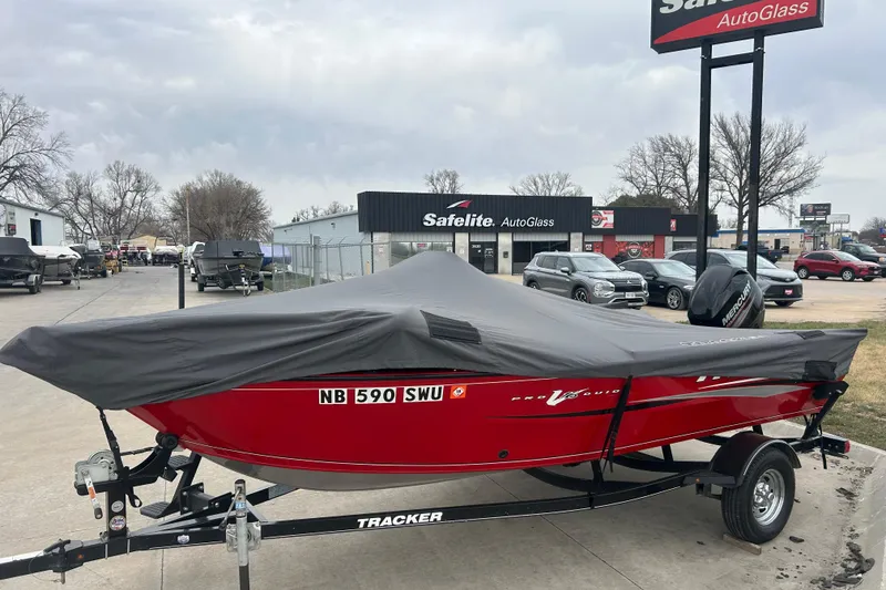 Slide: The Image of 2016 Tracker Pro Guide V-16 SC boat with cover, parked at Safelite AutoGlass. - 8