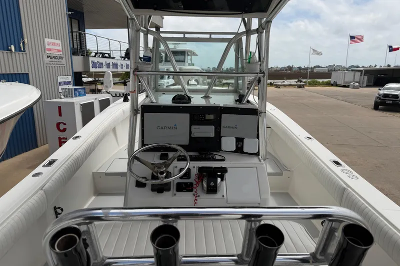 Slide: The Image of 1997 Regulator 26 Center Console boat with Garmin navigation, docked at a marina. - 10