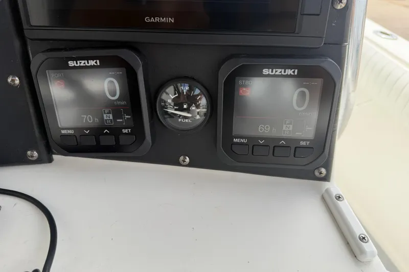Slide: The Image of Suzuki marine gauges and fuel indicator on a 1997 Regulator 26 Center Console boat. - 14