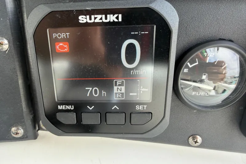 Slide: The Image of Suzuki engine display and fuel gauge on 1997 Regulator 26 Center Console boat. - 15