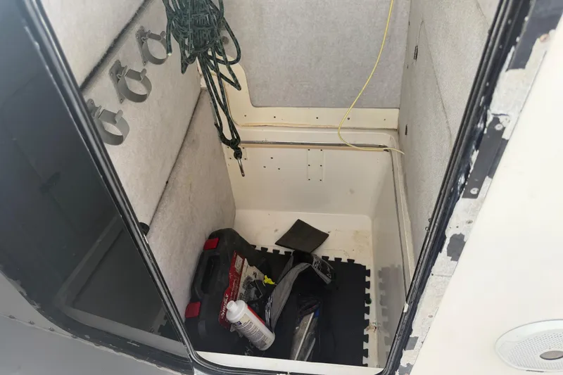 Slide: The Image of Interior storage compartment of a 1997 Regulator 26 Center Console boat. - 16